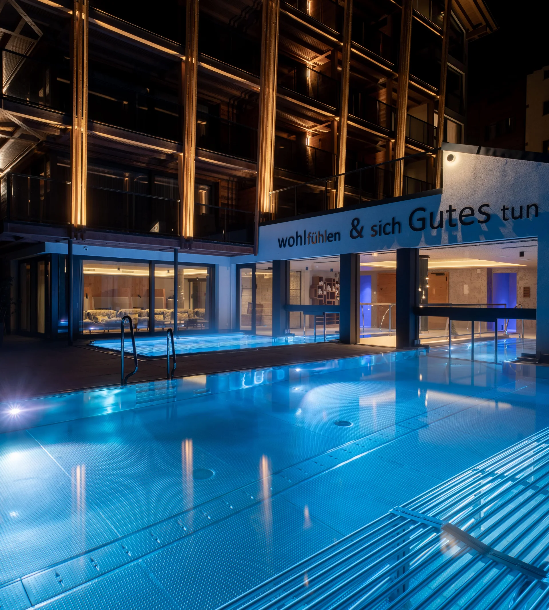 Why Choose La Ginabelle Illuminated hotel with infinity pool at night.
