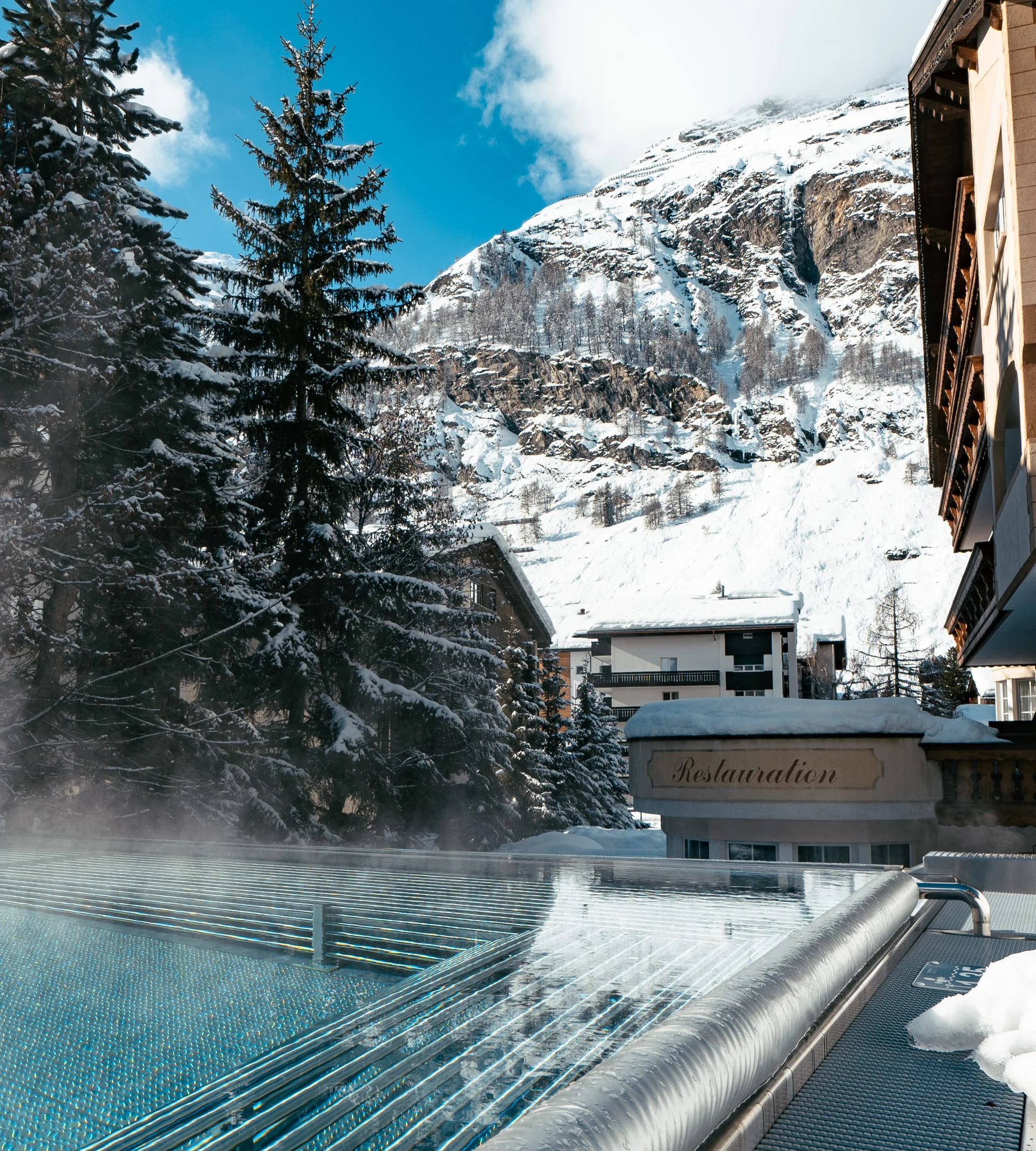 Why Choose La Ginabelle Infinity pool with massage jets and view of the snow-covered mountains in winter.