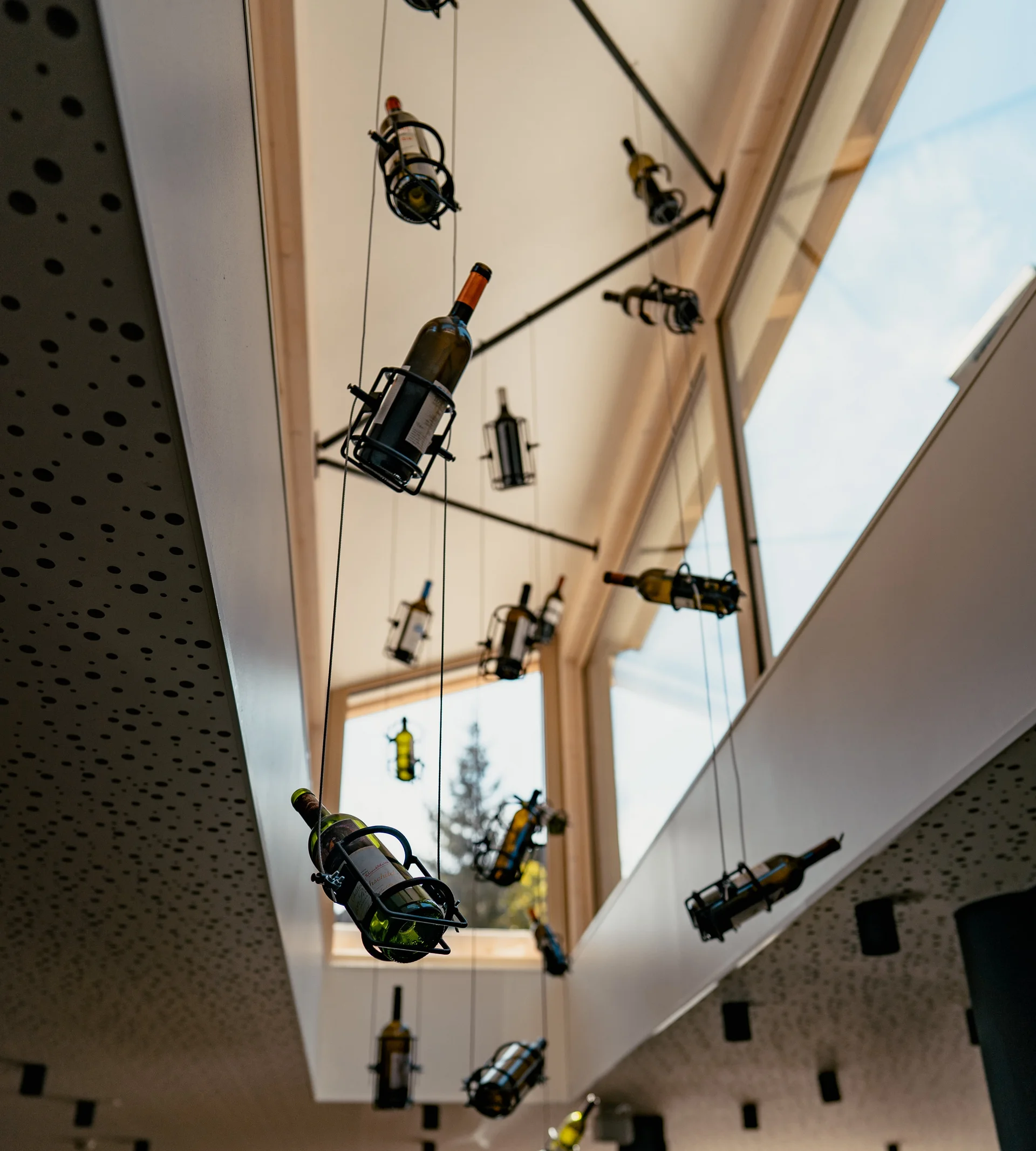 Restaurants at La Ginabelle - Resort La Ginabelle Zermatt Hanging wine bottles as an eye-catcher in a light tower