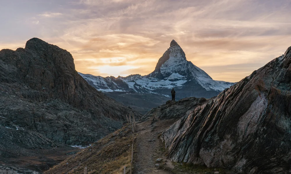 Wanderer vor Matterhorn bei Sonnenuntergang in den Alpen