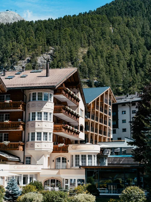 Hotel in summer with beautiful weather and mountains in the background.