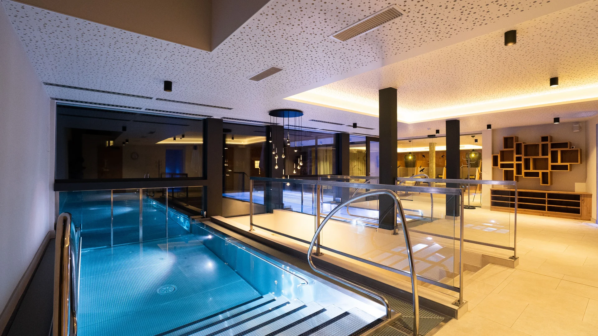 Indoor entry of the infinity pool with atmospheric lighting.